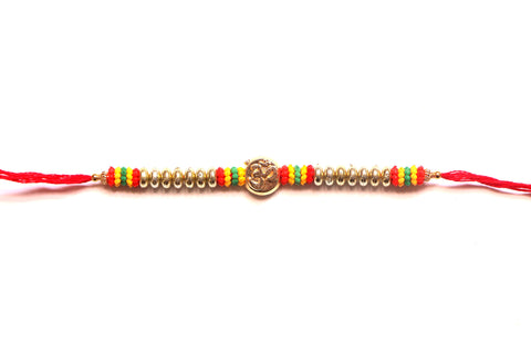 Om Rakhi in gold with colorful beads - OnlinePrasad.com
